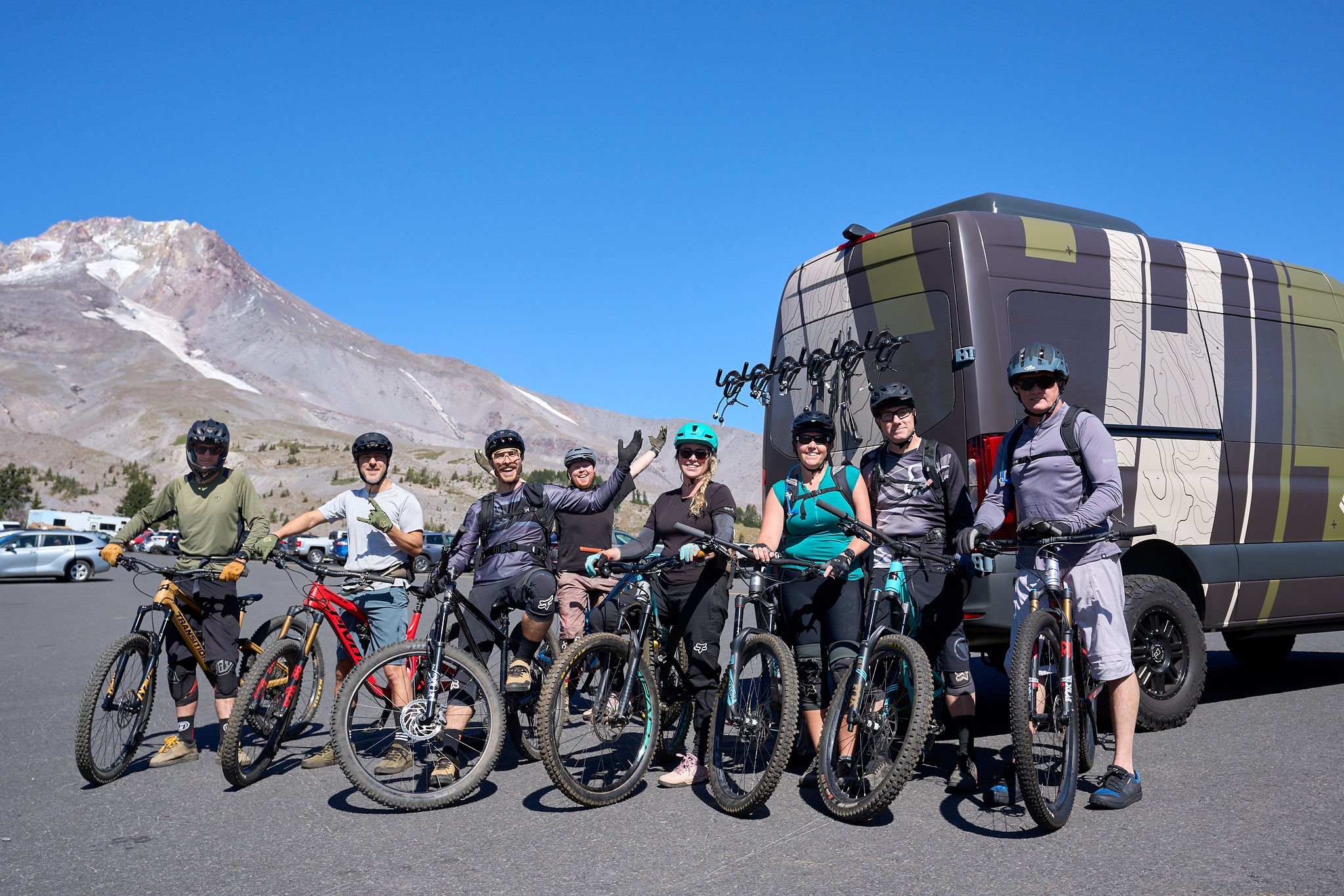 Group of mountain bikers smiling at Mt. Hood